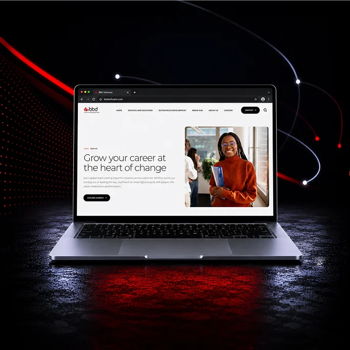 Laptop displaying a career growth website, featuring a smiling woman holding a binder. Red and black background.