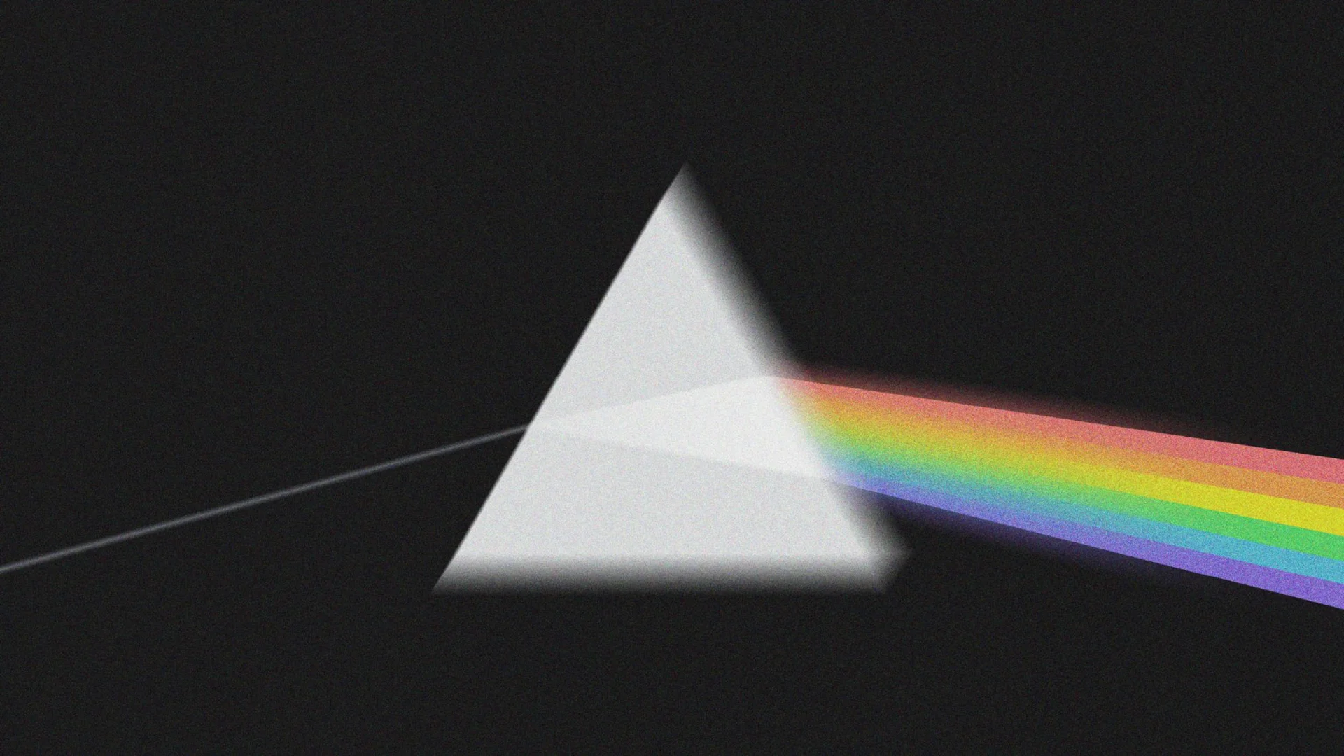 A prism disperses light into a rainbow spectrum against a black background.