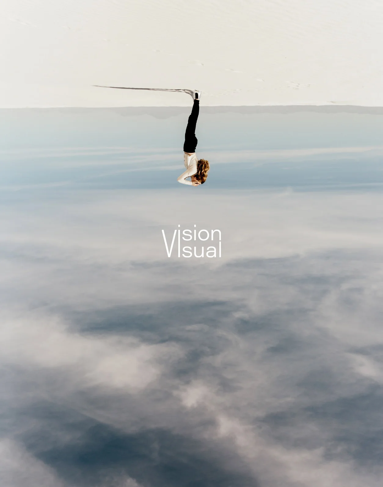 A person hangs upside down, balancing on a thin line above a tranquil, cloudy landscape.