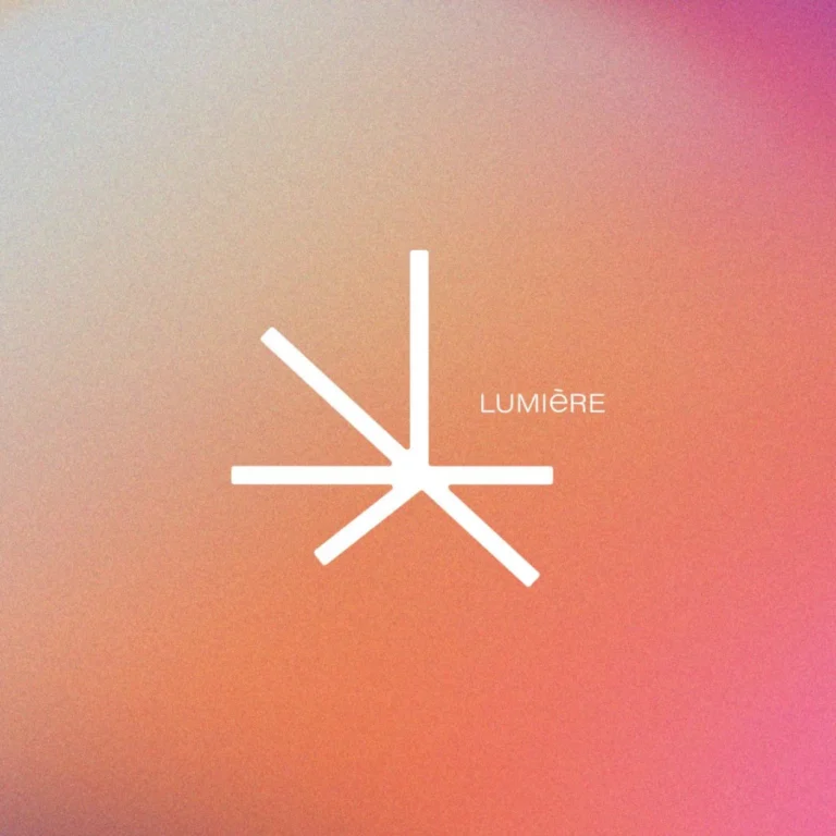 Stylized white logo of "Lumière" on a soft gradient background of orange and pink hues.